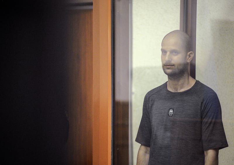 Wall Street Journal reporter Evan Gershkovich, who faces charges of espionage, stands inside an enclosure for defendants as he attends a court hearing in Yekaterinburg, Russia July 19, 2024. 