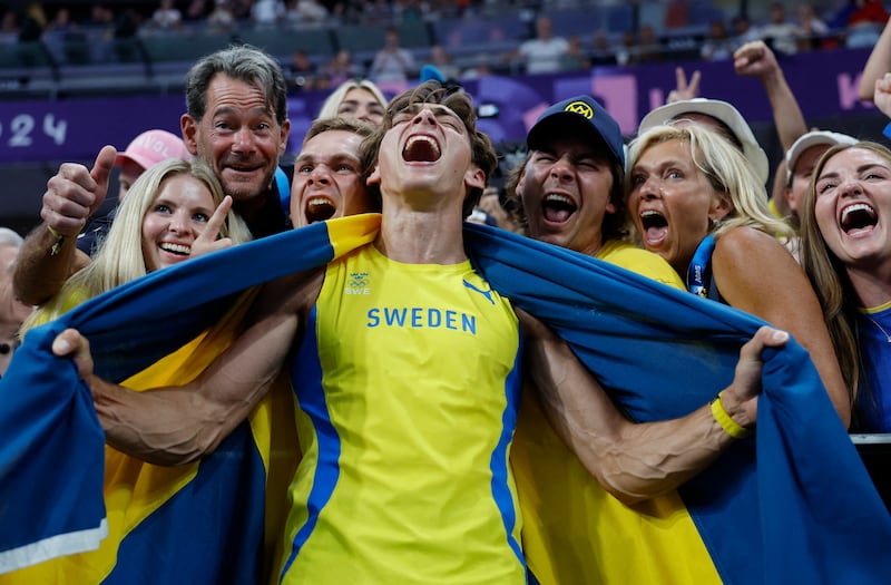 Mondo Duplantis of Sweden celebrates after winning gold in the men's pole vault competition at the 2024 Olympic Games.