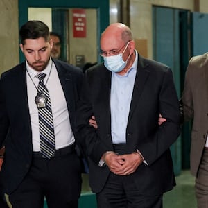 Trump Organization's former Chief Financial Officer Allen Weisselberg walks handcuffed at Manhattan Criminal Court.