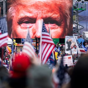 An image of President Donald Trump appears on video screens before his speech to supporters from the Ellipse at the White House in Washington on Wednesday, Jan. 6, 2021.