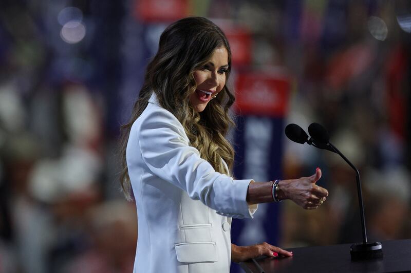 Kristi Noem smiles and gives a thumbs up on stage at the RNC.