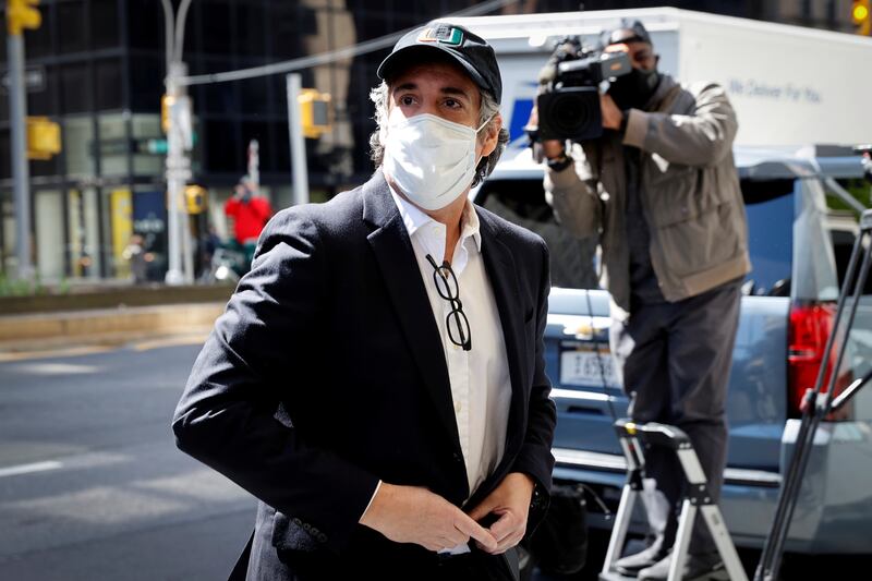 Michael Cohen, the former personal lawyer for U.S. President Donald Trump arrives at his Manhattan apartment wearing a mask and baseball cap