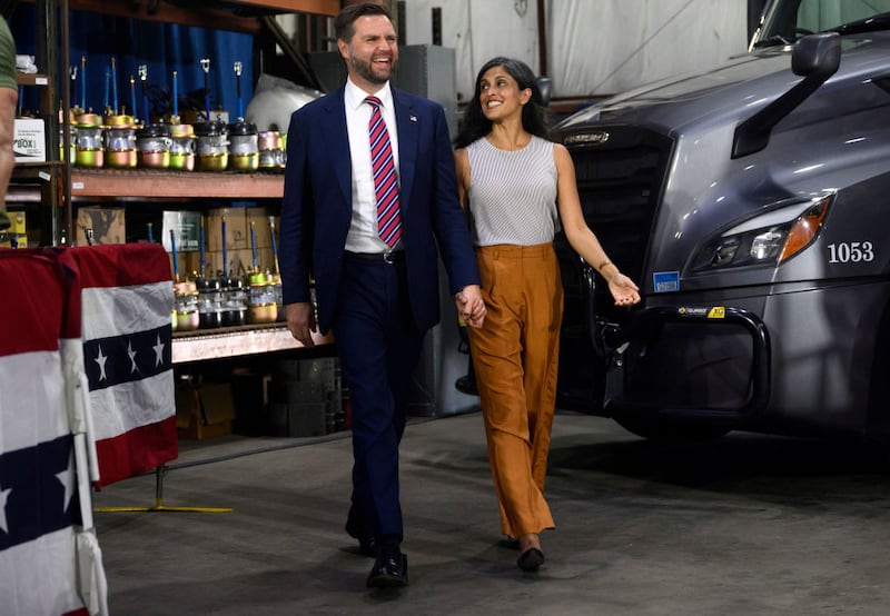 Republican vice presidential nominee, U.S. Sen. J.D. Vance (R-OH) walks on stage with his wife, Usha before speaking at a rally at trucking company, Team Hardinger on August 28, 2024 in Erie, Pennsylvania.