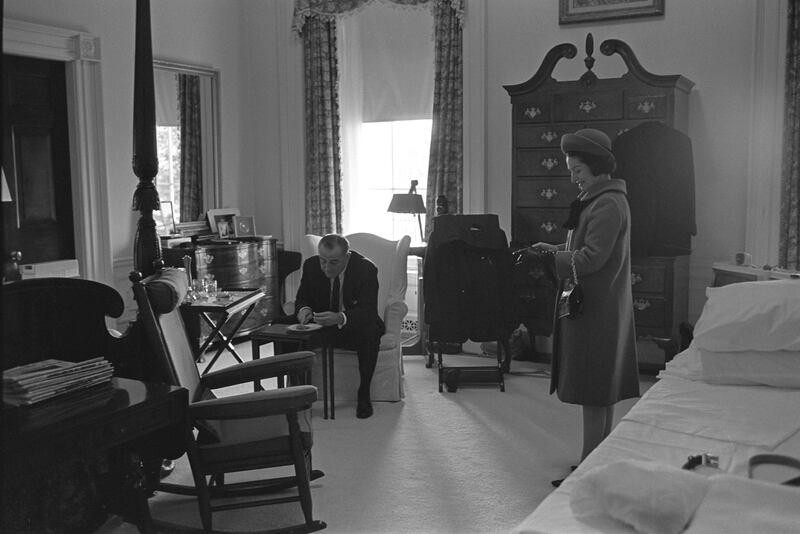 President-elect Lyndon B. Johnson and Lady Bird Johnson in a black and white photo.They are in what appears to be their White House bedroom