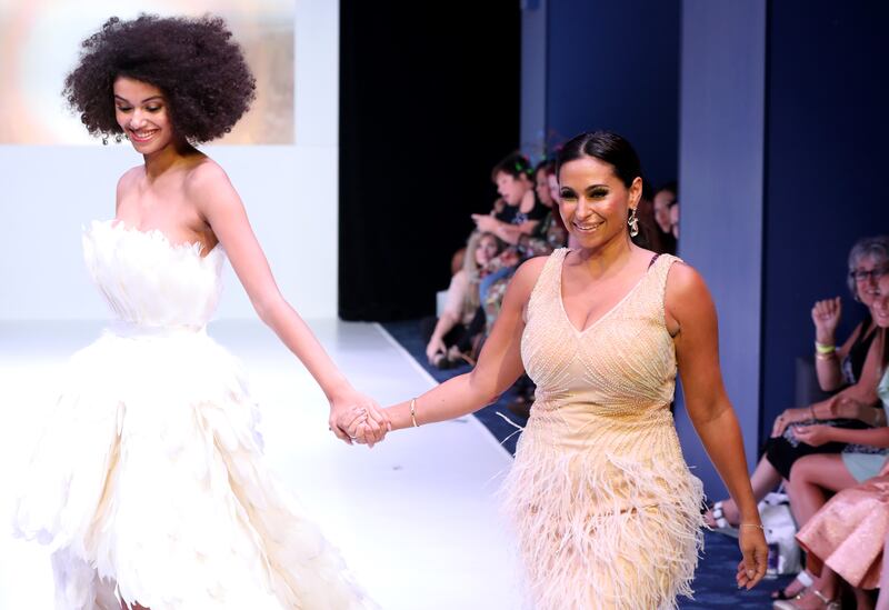 Laylah Rose walks the runway with a model during New York Fashion Week in 2019.