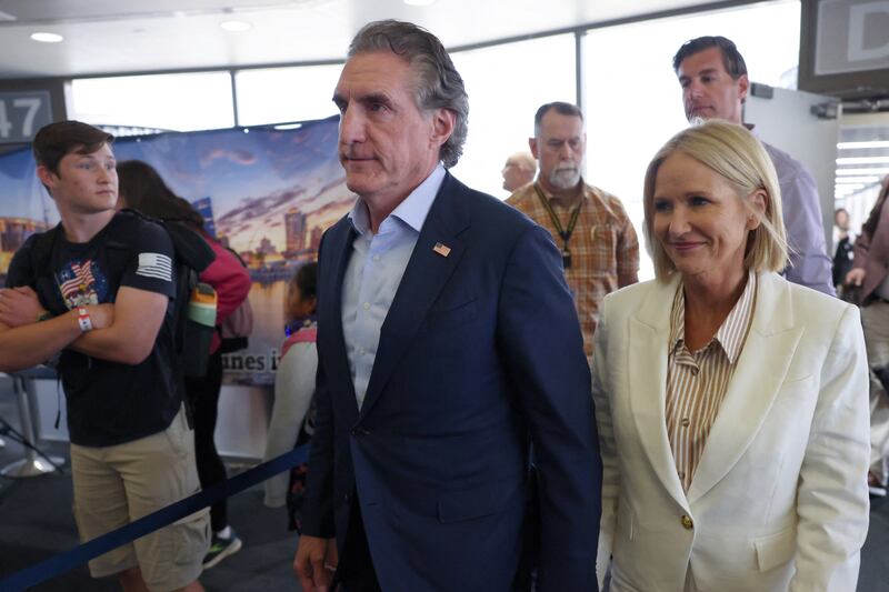 North Dakota Gov. Doug Burgum stares forward as he enters the RNC.