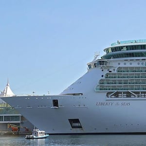 A side view of Liberty of the Seas as the cruise ship sits in port.