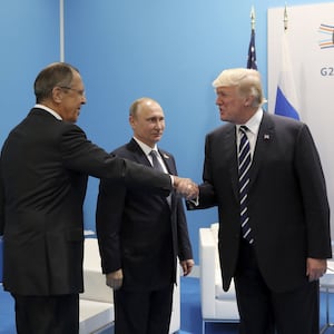 Former President Donald Trump shakes hands with Russian Foreign Minister Sergei Lavrov and Russian President Vladimir Putin 