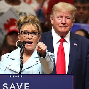 Republican U.S. House  candidate former Alaska Gov. Sarah Palin (L) speaks as former U.S. President Donald Trump (R) looks on during a "Save America" rally at Alaska Airlines Center on July 09, 2022 in Anchorage, Alaska. Former President Donald Trump held a "Save America" rally in Anchorage where he campaigned with U.S. House candidate former Alaska Gov. Sarah Palin and U.S. Senate candidate Kelly Tshibaka.