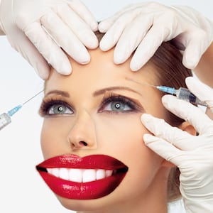 image of woman with bigger red lipstick lips and eyes and hands holding needles medscape medicine health plastic surgery surgeon happiness satisfaction burnout depression suicide celebrity boob job butt cosmetic reconstruction reconstructive money