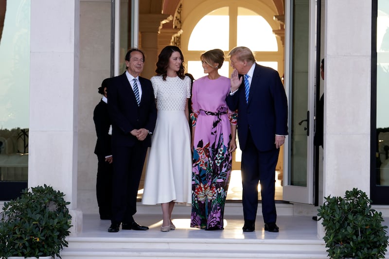 Republican presidential candidate and former US President Donald Trump (R) and former first lady Melania Trump (2nd-R) arrive at the home of John Paulson (L) with Alina de Almeida (2nd-L) on April 6, 2024 in Palm Beach, Florida.