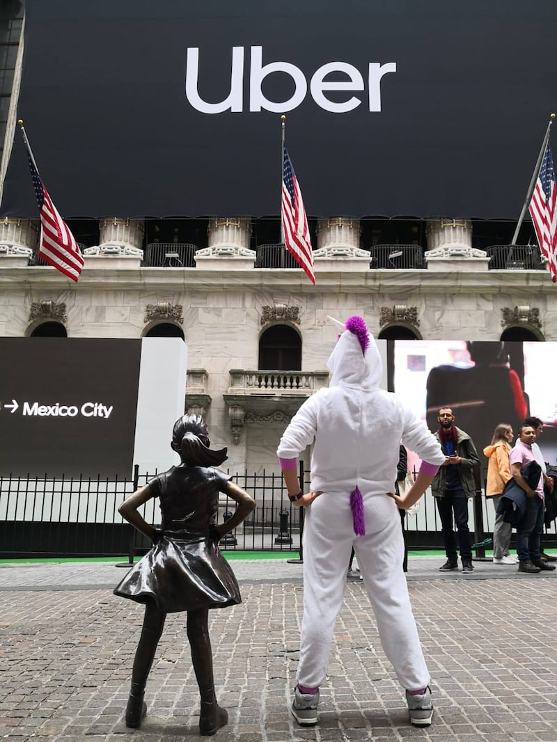 An image of ex-Uber engineer Yukti Abrol wearing a unicorn costume outside the NYSE.