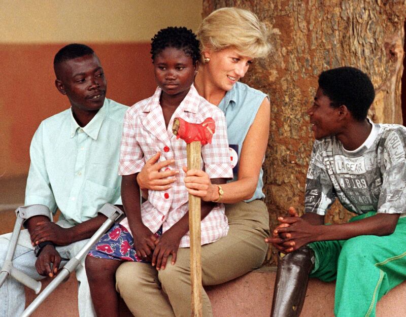 Princess Diana holds an Angolan amputee child on her lap in Luanda, Angola.