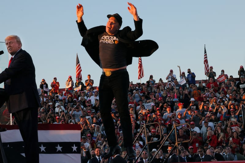 Elon Musk reacts next to Republican presidential nominee and former U.S. president Donald Trump during a campaign rally, at the site of the July assassination attempt against Trump, in Butler, Pennsylvania, U.S., Oct. 5, 2024.