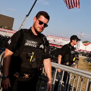 Secret Service agents walk in aftermath of Trump rally shooting.