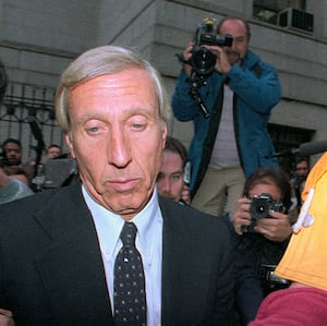 Ivan Boesky is photographed while being escorted out of a courthouse.