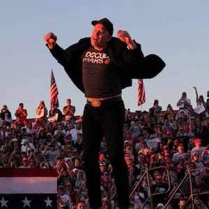 Tesla CEO and X owner Elon Musk jumps on the rally stage.