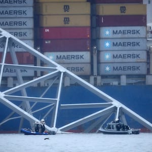 Emergency diver teams work at the site of the wreckage of the Dali cargo vessel, which crashed into the Francis Scott Key Bridge causing it to collapse, in Baltimore, Maryland, U.S., March 27, 2024. 