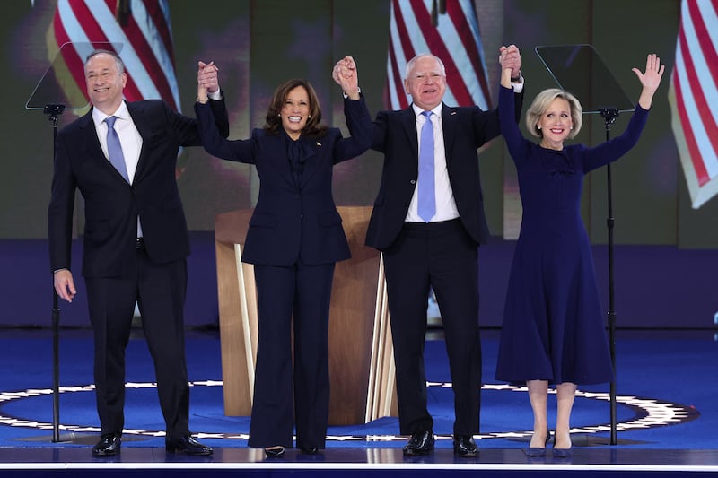 Vice President Kamala Harris celebrates with her husband, second gentleman of the U.S. Doug Emhoff, vice presidential nominee Minnesota Governor Tim Walz, and his wife Gwen Walz. 