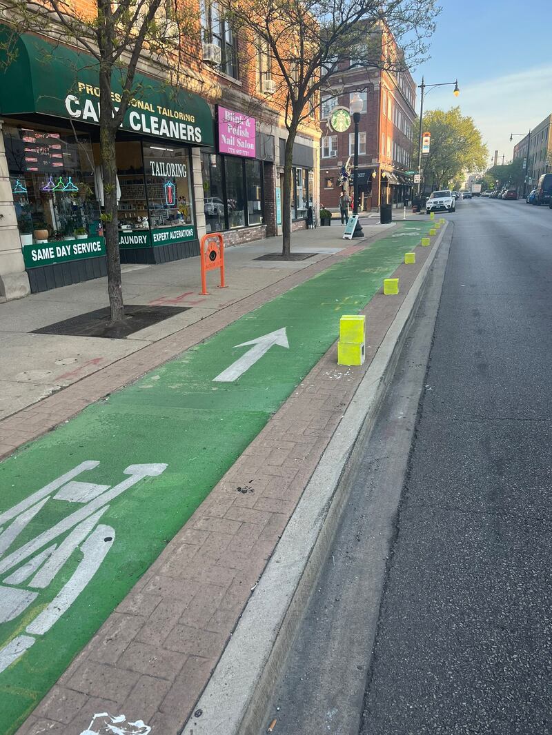 A bootleg bicycle lane barrier created by the People's CDOT out of cinder blocks. 