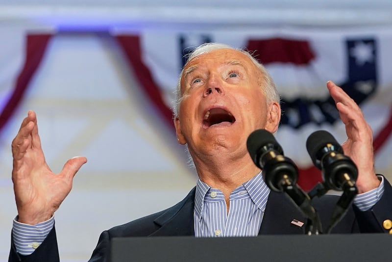 U.S. President Joe Biden looks up with his mouth open during a campaign event at Sherman Middle School