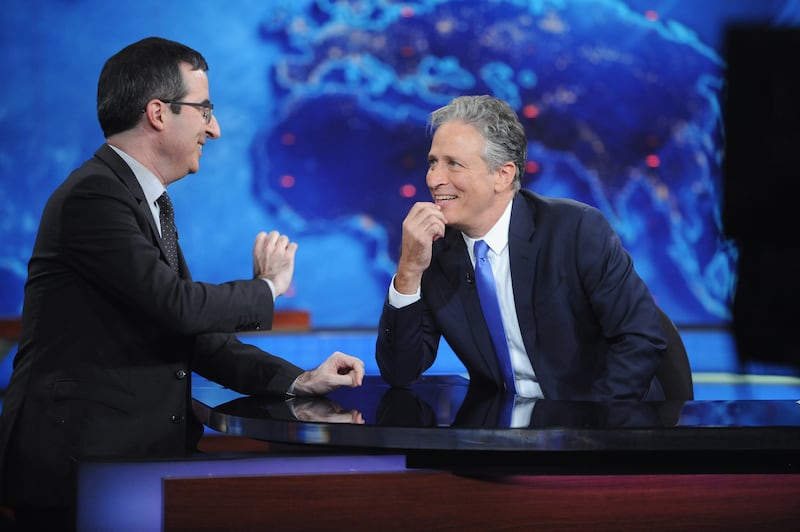 John Oliver and host Jon Stewart appear on "The Daily Show with Jon Stewart" on August 6, 2015 in New York City.