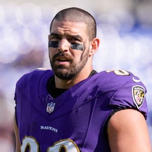 Mark Andrews, in uniform, stands on the sideline during an NFL game.