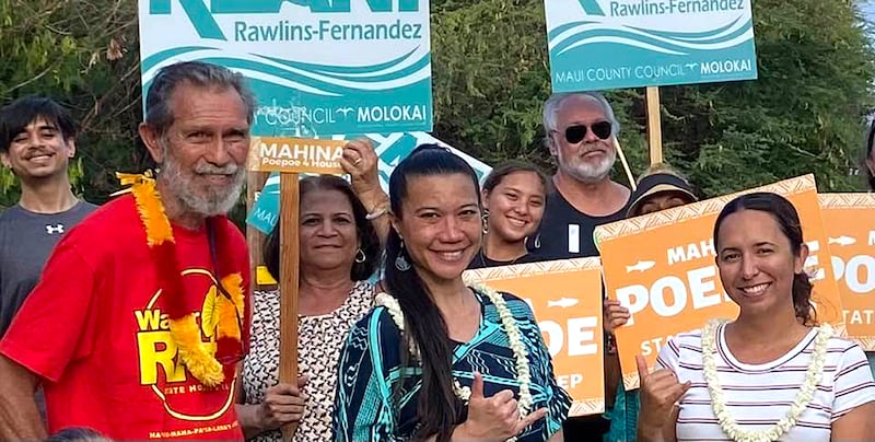 Walter Ritte and Maui County Councilmember Keani Rawlins-Fernandez stand in a group on the island of Molokai.