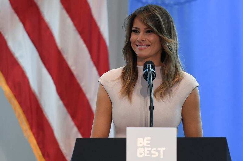 Melania Trump behind a lectern marked Be Best