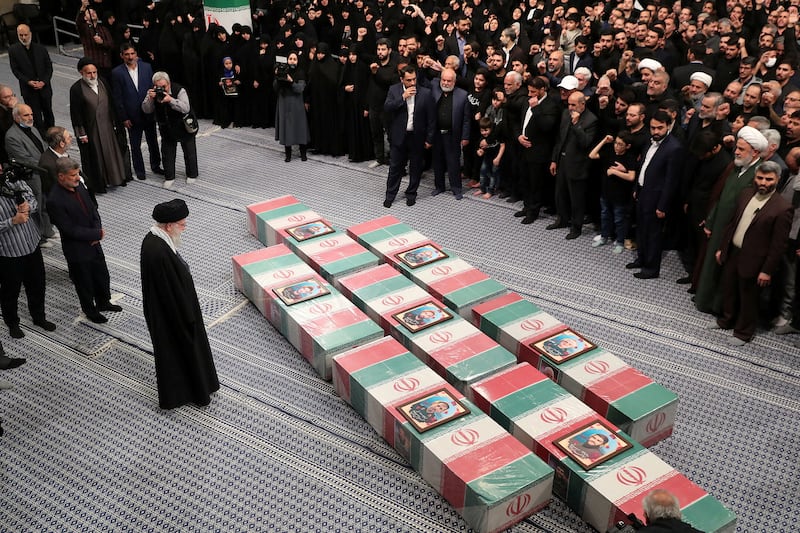 Iran's Supreme Leader, Ayatollah Ali Khamenei looks at the coffins of members of the Islamic Revolutionary Guard Corps.