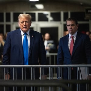 Former U.S. President Donald Trump speaks to the media as he leaves court with his attorney Todd Blanche.