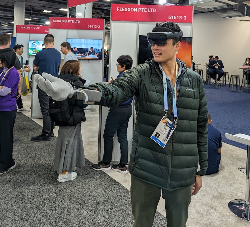 Tony Ho Tran holds a beating heart with a haptic glove from Microtube Tech in virtual reality. 