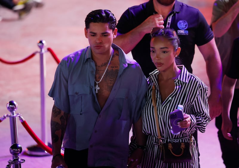 Ryan Garcia accompanied by a woman 