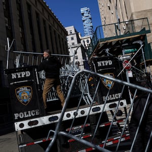 Men set up NYPD barricades outside Manhattan Criminal Court in New York City