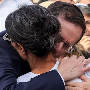 Israel's President Isaac Herzog and his wife Michal Herzog embrace Rachel Goldberg 