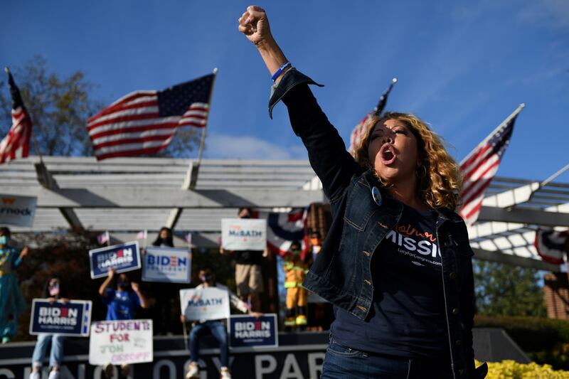 Lucy McBath raises her fist while campaigning in 2020.