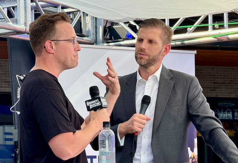 Eric Trump speaks with political commentator and YouTuber Benny Johnson (L) outside the Fiserv Forum during the second day of the 2024 Republican National Convention in Milwaukee, Wisconsin, July 16, 2024. Days after he survived an assassination attempt Donald Trump won formal nomination as the Republican presidential candidate and picked right-wing loyalist J.D. Vance for running mate, kicking off a triumphalist party convention in the wake of last weekend's failed assassination attempt.