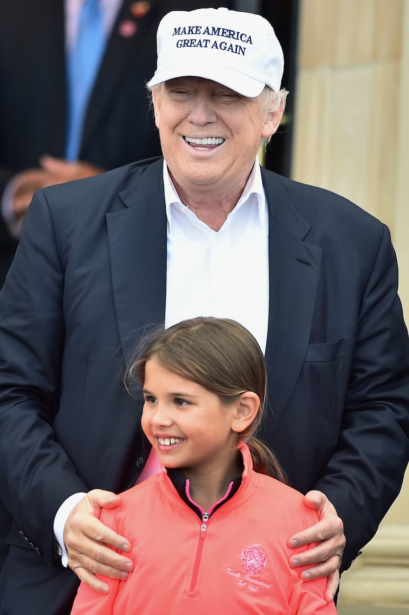 Then-nominee for U.S. President Donald Trump and his granddaughter Kai Trump at his Trump Turnberry Resort in 2016.