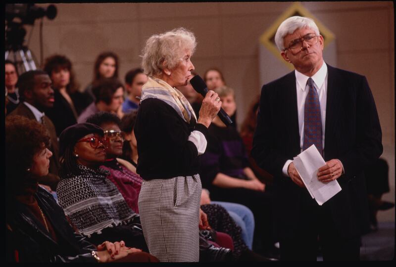 Phil Donahue with a member of the audience who is speaking