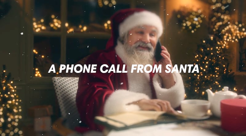 An AI-generated image of Santa Claus on his cellphone, courtesy of SantaPhoneCalls.com