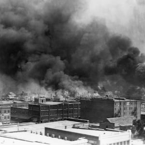 Black smoke billows from fires during the Tulsa Race Massacre of 1921