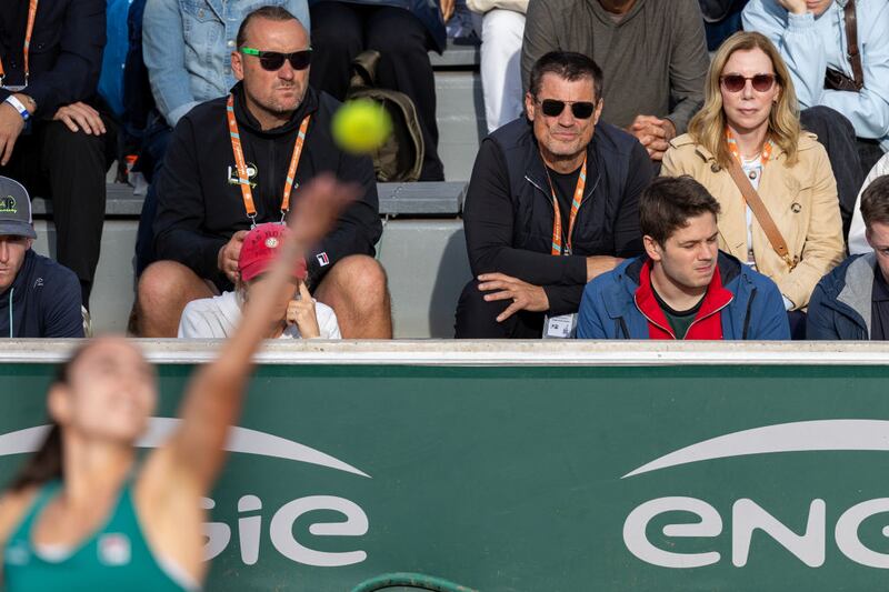 Ben and Kelly Navarro watch their daughter from the stands.