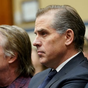 Hunter Biden, wearing a suit and tie, sits during a court hearing.