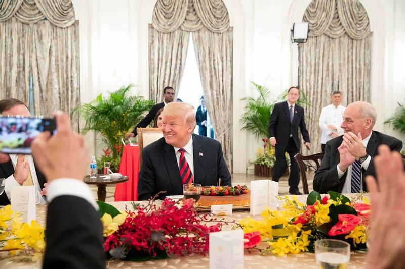 Prime Minister Lee Hsien Loong of Singapore surprises Donald Trump with a birthday cake in 2018.