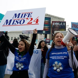 A demonstrator for abortion rights holds a megaphone during a protest outside the U.S. Supreme Court as justices hear oral arguments in a bid by President Joe Biden's administration to preserve broad access to the abortion pill, March 26, 2024.