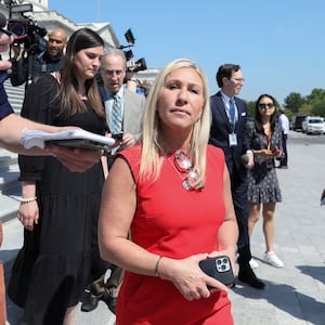 U.S. Rep. Marjorie Taylor Greene walks through reporters on Capitol Hill.