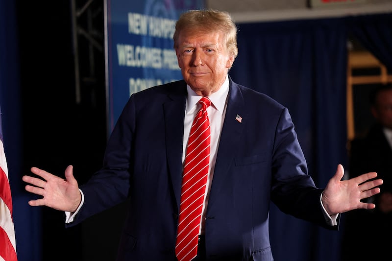 Former President Donald Trump gestures at a rally in advance of the New Hampshire primary