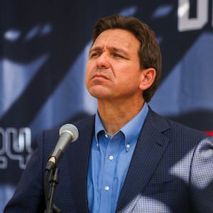 Ron DeSantis stares forward while speaking at a barbecue in New Hampshire.