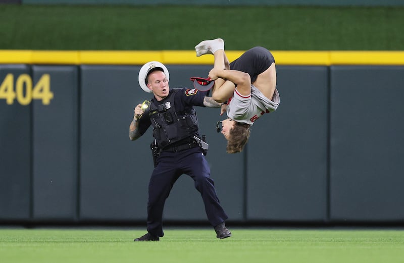 William Hendon does a backflip while a police officer attempts to tase him.