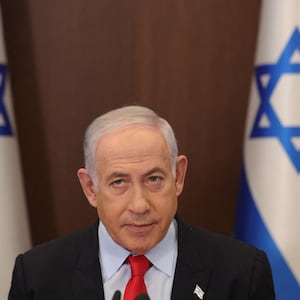 Israeli Prime Minister Benjamin Netanyahu before Israeli flags